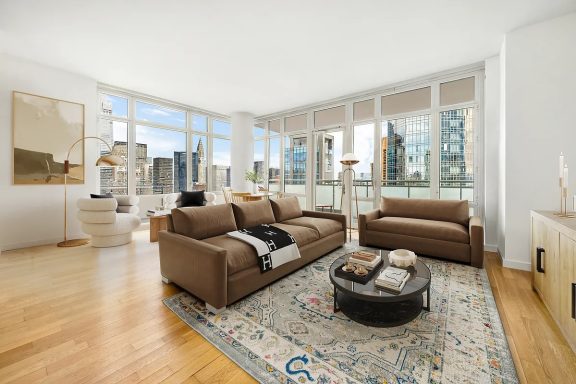 Corner Living room Spacious living room with large windows, brown sofas, and a stylish area rug.