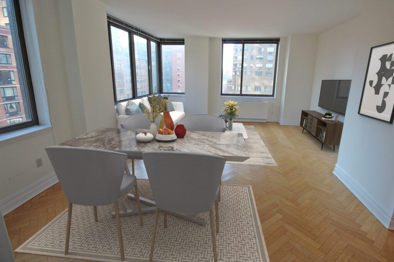 2 Columbus Ave Living Room Modern dining area with a marble table, gray chairs, and large windows for natural light.