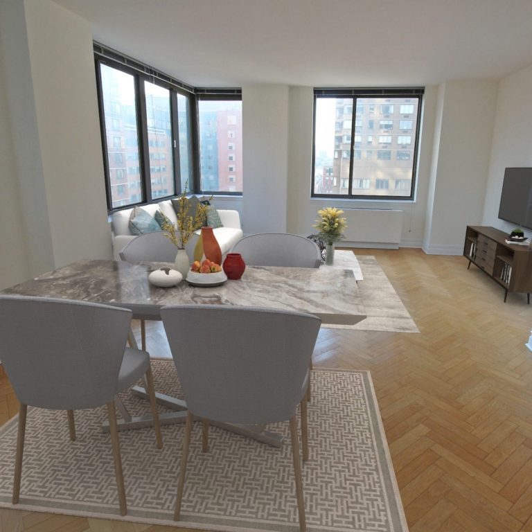 2 Columbus Avenue Living room Bright, modern living area with a dining table, chairs, and large windows showing city views.