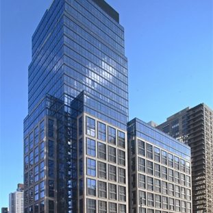 The building 200 WEA Modern high-rise building with a mix of glass and brick facade against a clear blue sky.