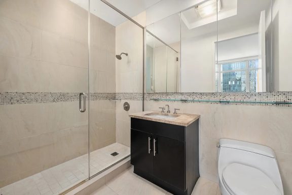 Nice bathroom Modern bathroom featuring a walk-in shower, vanity, and neutral-colored tile.