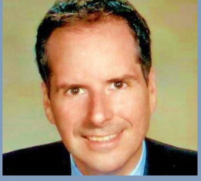 Frederico Ziotto Smiling man with short dark hair, wearing a suit and tie.