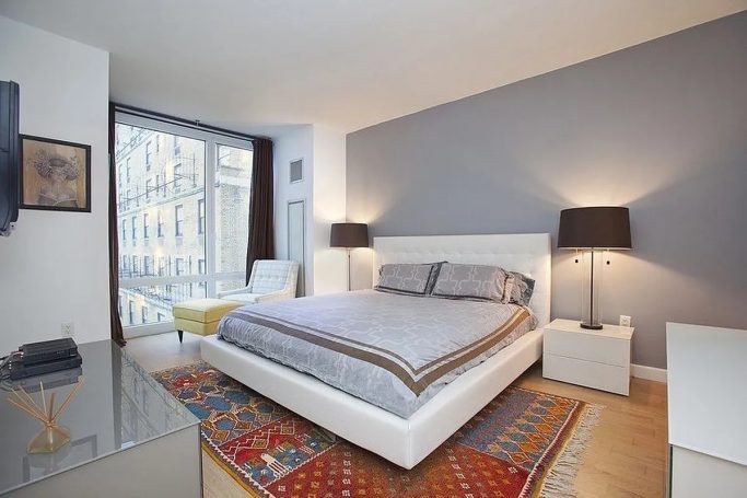 Master Bedroom Modern bedroom featuring a queen bed, large windows, and stylish decor.