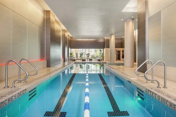 Indoor swimming Pool Indoor swimming pool with modern design and clear water, flanked by pillars.